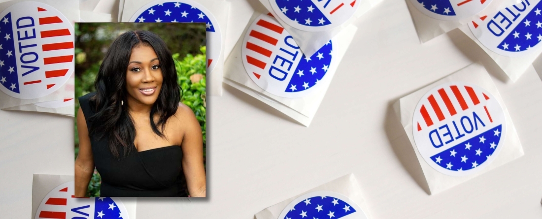 Nykidra Robinson headshot, background is voted stickers