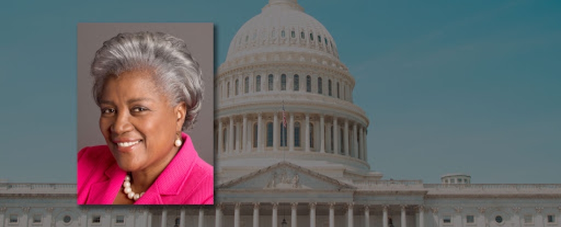 Headshot of Brazile in front of an image of the Capitol