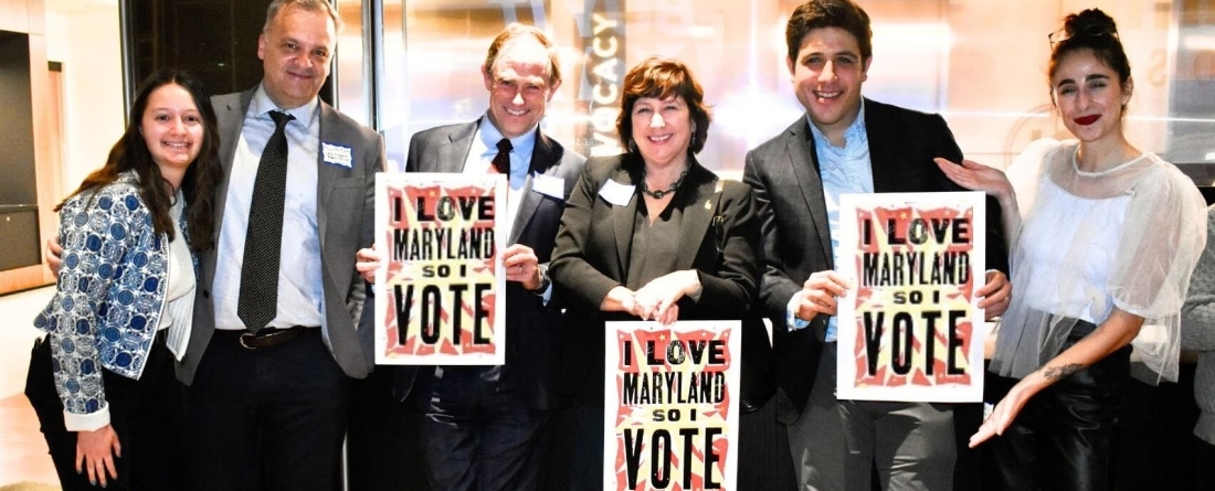 image of Paul Brown, Dean Robert C. Orr, and others at the National Student Vote Summit holding sings that say "I love Maryland so I vote"
